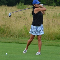 An alumna golfing at the Meadows Golf Course.